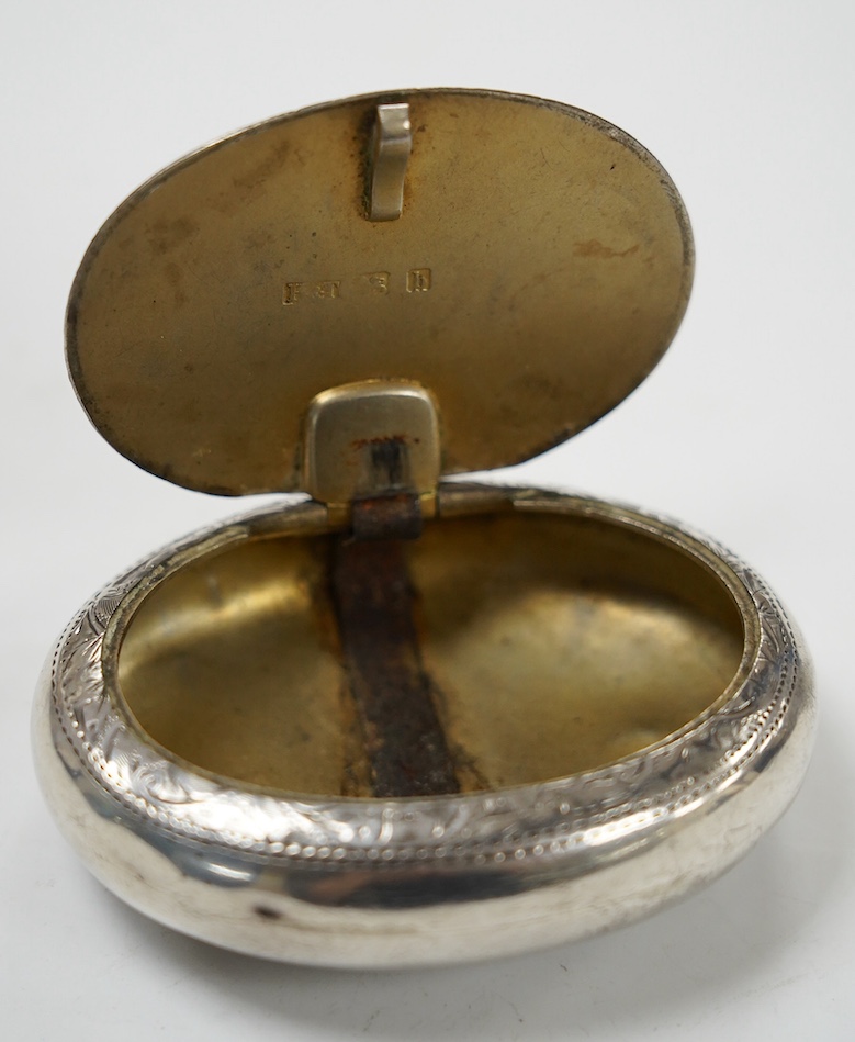 An Edwardian engraved silver oval tobacco box, Hilliard & Thomason, Birmingham, 1901, 75mm. Condition - poor to fair
